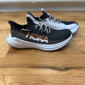 Men’s Hoka Black, White and Gold Athletic Shoes